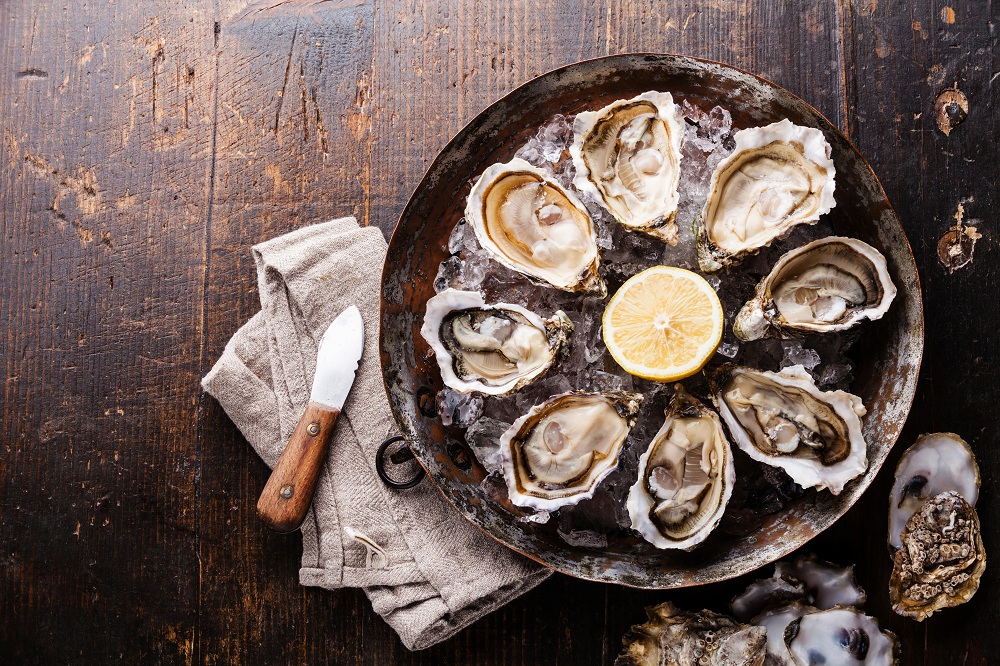 Raw oysters on wood board